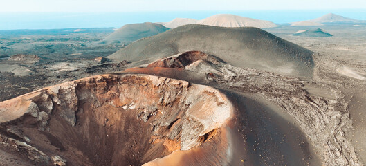 A beautiful view of a volcano crater, desert, mountains and volcanoes on the Lanzarote island.