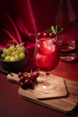 lifestyle image of cranberry juice with bowl with grapes 