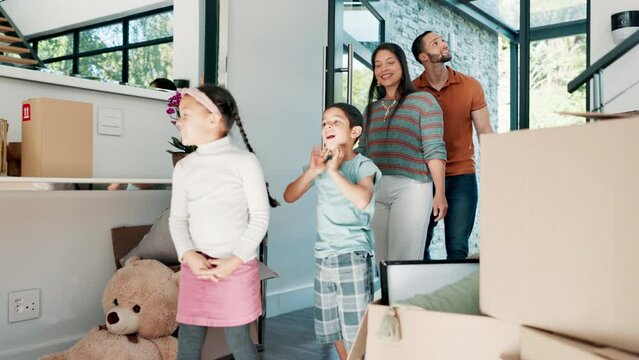 Family moving, new home and kids with parents excited for mortgage, investment and real estate in foyer or entrance. Dad, mom and children walking in front door with boxes for dream house or property