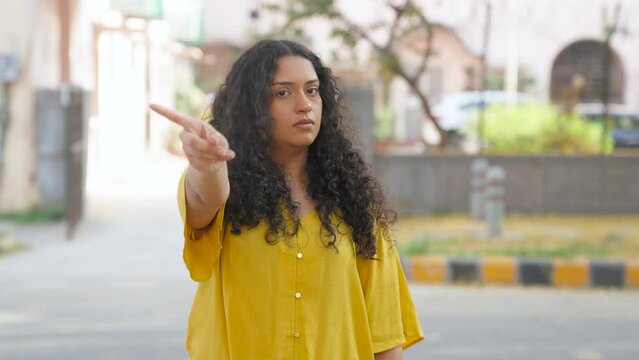 Indian Girl with Curly Hair Saying No With Finger at Camera 