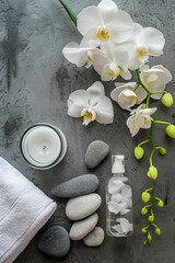Orchids and stones on a gray spa background. Selective focus.