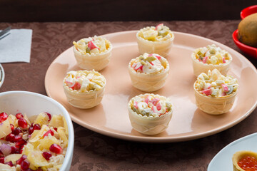Throw forks on the table set with salad in tartlet appetizers