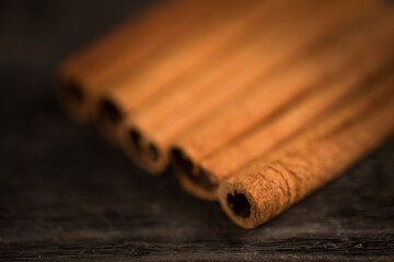 Cinnamon sticks on wooden background