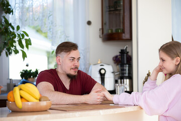 A couple in love sits across from each other and looks deeply into each other's eyes.