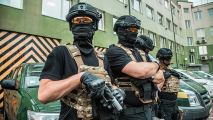 Elite tactical unit ready for operation, fully equipped special forces officers with modern gear against urban background
