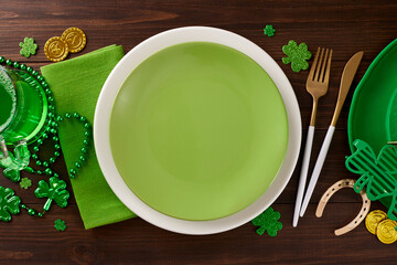 Green delights: Festive dining for St. Patrick's celebration. Top view photo of plates, cutlery,...