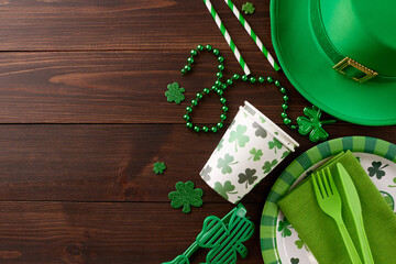 Enchanting green gala: St. Patrick's Day soiree. Top view of paper plate, cutlery, cups, straws,...