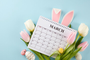 Anticipating Easter: the countdown to joyful festivities. Top view photo of calendar, bunnies ears, eggs, flowers on light blue background - obrazy, fototapety, plakaty