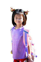 Happy Child Girl wearing reindeer hairpin and carrying backpack, ready for festive school day, Isolated White Background. Smiling Asian Kid with Brown Reindeer Hairband to get into Christmas festival.