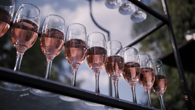 Champagne glasses stand in a row