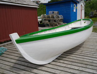 Beautifully painted white and green skiff or rowboat on a working dock in Dildo Newfoundland