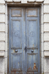 A Weathered Blue Paneled Wooden Door in a Crypt in Recoleta Cemetery, Buenos Aires, Argentina