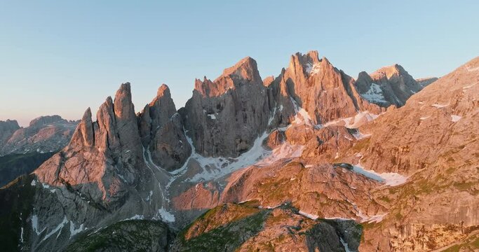 Aerial view beautiful Dolomite mountain Alps dawn range against blue sky on sunny day Italy. Top view drone of high rocks, mountain peaks. Tourism travel concept. Amazing nature scenery in Dolomites