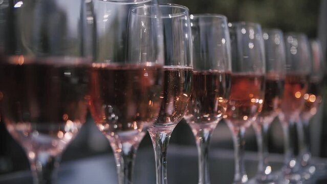 Champagne glasses stand in a row