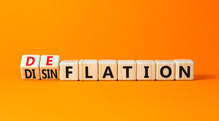 Deflation or disinflation symbol. Concept word Deflation Disinflation on beautiful wooden cubes. Beautiful orange table orange background. Business deflation disinflation concept. Copy space.