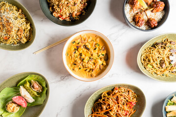 Table brimming with an array of delectable Asian dishes. The rich and diverse flavors of Asian cuisine. High quality photo