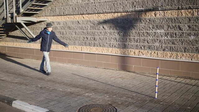 Boy throws bat and misses when he plays gorodki game.