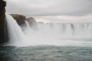 Traveling and exploring Iceland landscapes and famous places. Autumn tourism by Atlantic Ocean and mountains. Outdoor views on beautiful cliffs and travel destinations. Godafoss waterfall.