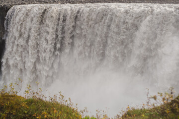 Traveling and exploring Iceland landscapes and famous places. Autumn tourism by Atlantic Ocean and mountains. Outdoor views on beautiful cliffs and travel destinations. Dettifoss waterfall.