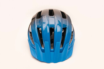 Fototapeta premium Bicycle helmet of blue and black color on white background with a shadow. Bicycle helmet for safe riding on a bicycle, scooter or rollerblades