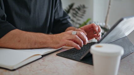 Closeup mature hands typing keyboard. Business owner making notes calculating
