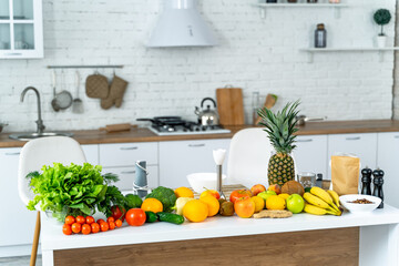 Abundant Fruits and Vegetables Cover Kitchen Counter in Vibrant Display. A vibrant display of numerous fruits and vegetables adorn the kitchen counter.