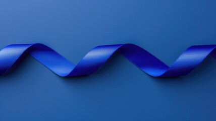 Obraz premium Blue satin ribbon on a solid blue background in a wavy pattern