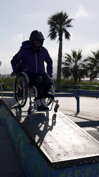 disable athlete man in wheelchair perform tricks in skatepark