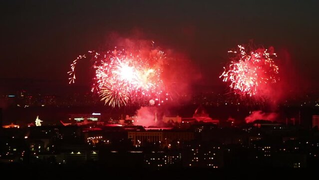 Beautiful bright fireworks above big city at night