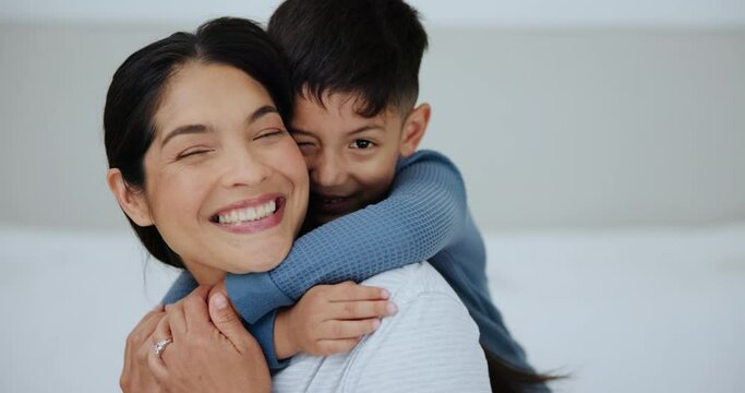 Love, surprise and son hugging mom in bedroom of home together for playful bonding. Portrait, smile or playing with happy woman parent and excited boy child laughing on bed in apartment as family