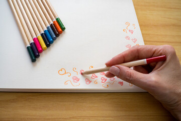 Hand Drawn Red Heart Photograph Row of Multicolored Pencils on White Background