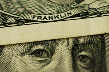 Closeup of Benjamin Franklin face on USD dollar banknote for dollar