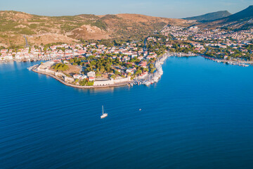 Yacht cruising near Foca resort town, Izmir region Turkiye. Aerial establishing shot
