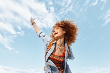 Cheerful Beach Adventure: Smiling Woman with Backpack Embracing the Freedom of Nature's Beauty.