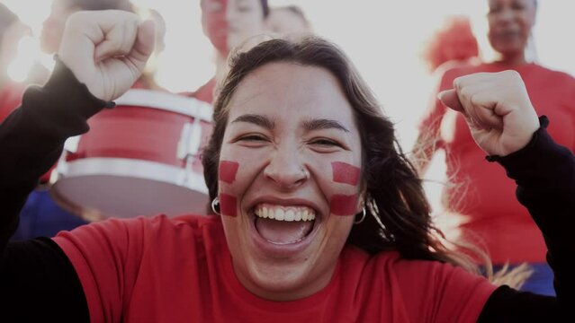 Latin sport fan celebrating with crowd team with stadium background. People cheering soccer championship games at world event competition