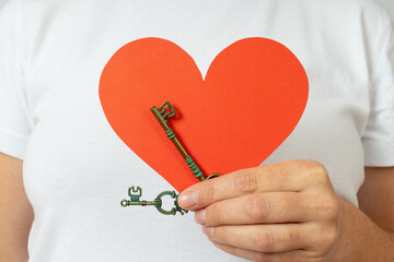 heart and two keys in one female hand