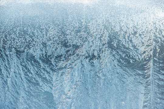 An ombre gradient ice texture on aluminium with frozen water on a cold winters day. Rich texture that can be used as a background or for photo editing resource