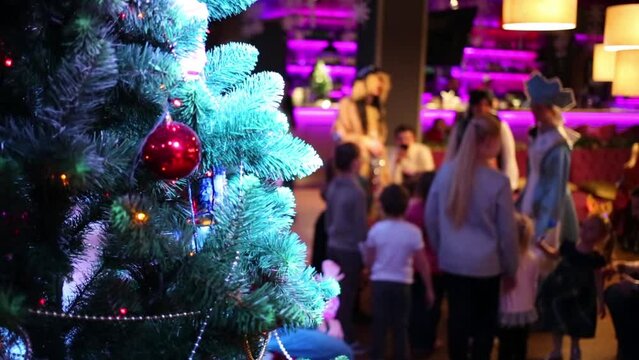 decorated Christmas tree and children out of focus during holiday