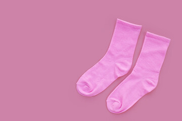 Pink socks on pink background.