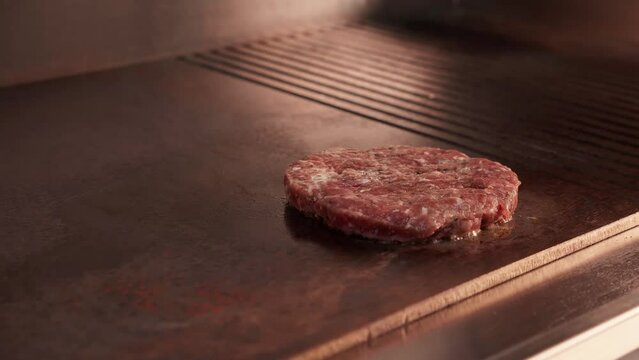 Cooking beef and pork patty for burger. Meat roasted at kitchen. Slow motion grilled burger cutlet. 