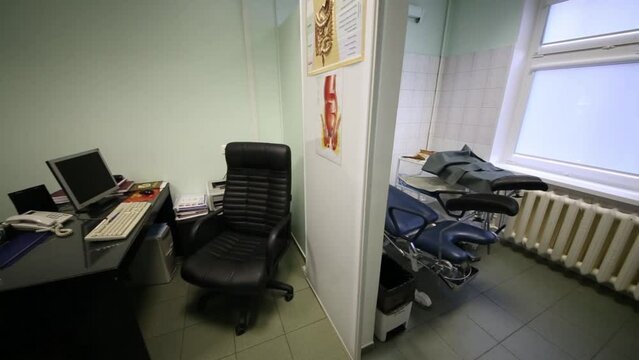 Empty gastroenterologist office with a desk and a viewing room