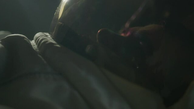 Man in astronaut suit putting helmet shade down - close up
