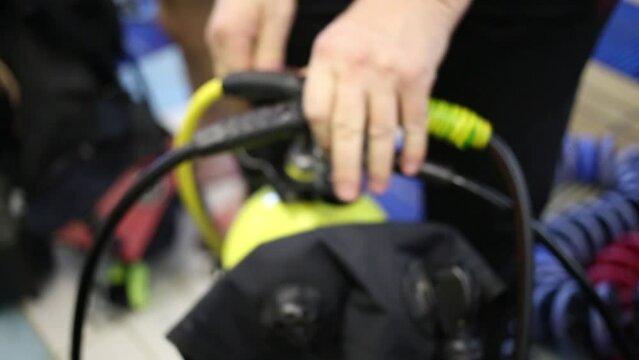 Male hands preparing aqualung equipment for diving