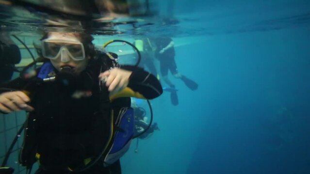 Woman with special equipment looks at camera in pool