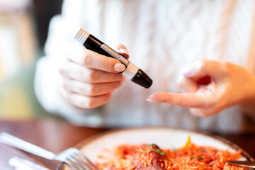 woman measuring blood sugar level