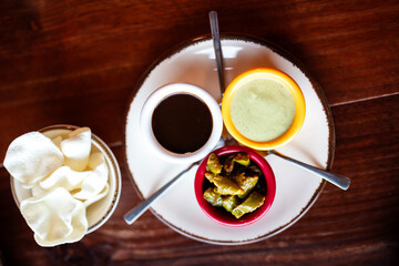 Set of three sauces on wooden table