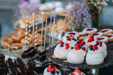 cream cakes with strawberries on a tray 