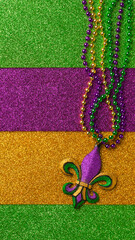 Mardi Gras beads with Fleur de lis, in glittering green, purple, and gold. Sparkling festive background for Mardi Gra in traditional colors. © Leigh Prather