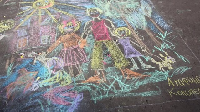 Bright chalk drawing Happy family on pavement. 