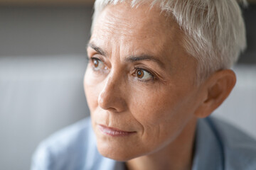 portrait of mature lady with gray short hair looking aside